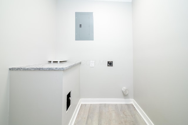 laundry room featuring electric panel, light hardwood / wood-style floors, and electric dryer hookup