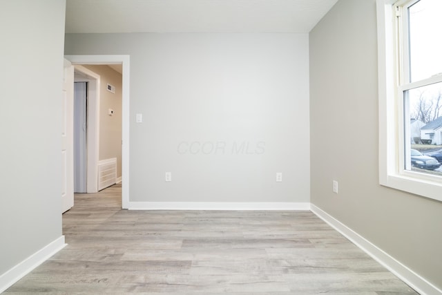 empty room with light hardwood / wood-style floors