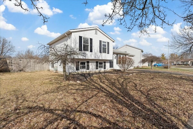 rear view of house featuring a lawn