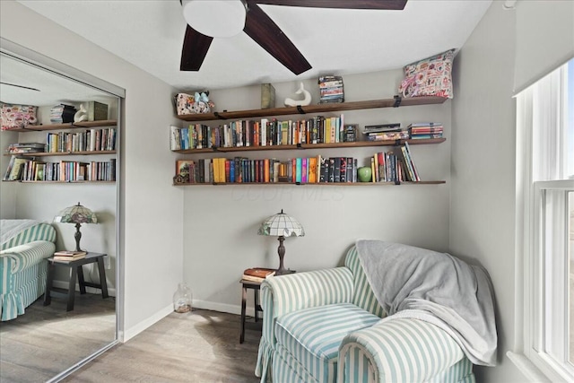 living area with hardwood / wood-style flooring and ceiling fan