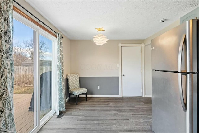 unfurnished room featuring hardwood / wood-style floors and a textured ceiling