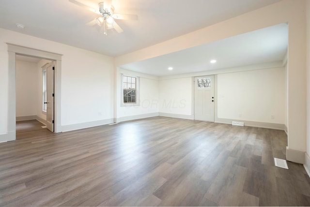 unfurnished room featuring dark hardwood / wood-style floors and ceiling fan