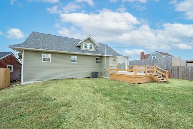 back of property with central AC, a lawn, and a deck