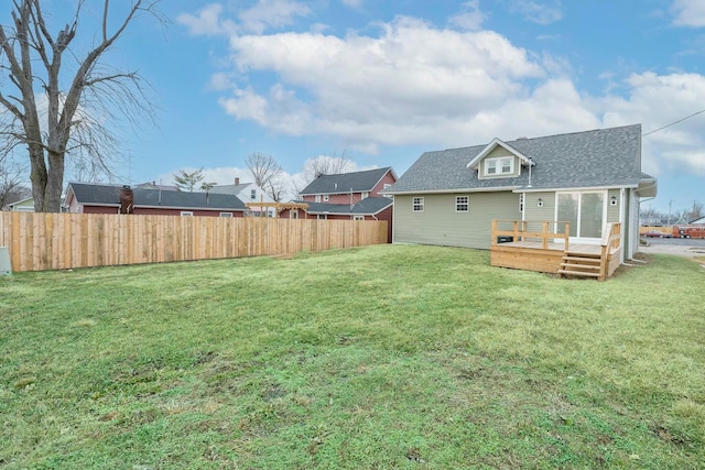 back of property with a wooden deck and a yard