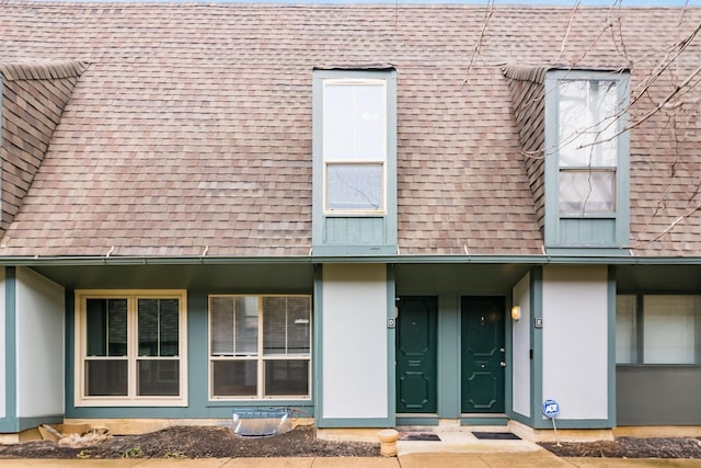 exterior space featuring a shingled roof