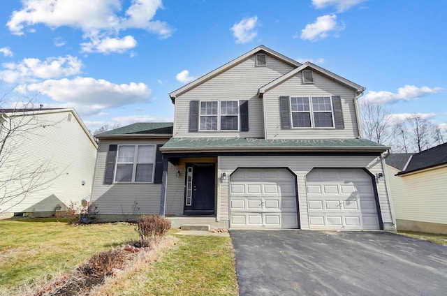 view of front of property featuring a garage and a front lawn