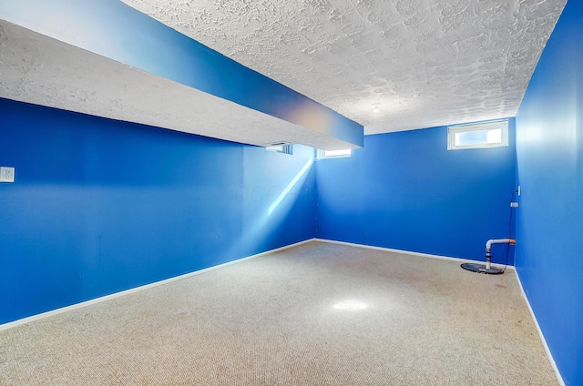 carpeted spare room featuring a textured ceiling