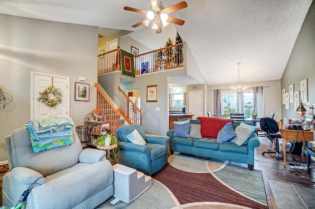 living room with hardwood / wood-style flooring, ceiling fan with notable chandelier, high vaulted ceiling, and a textured ceiling