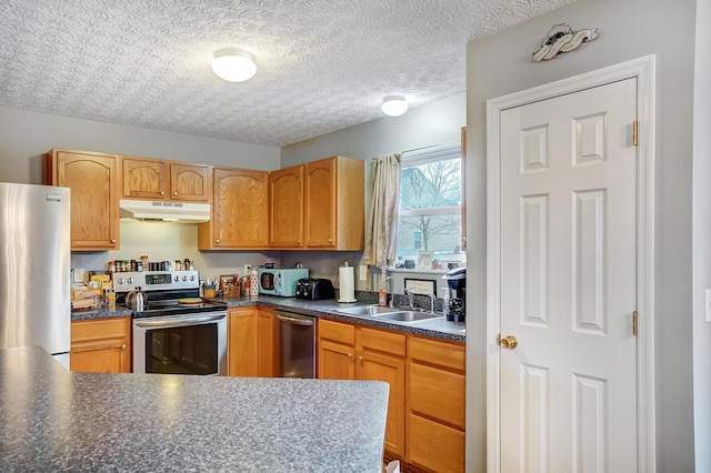 kitchen featuring sink, a textured ceiling, and appliances with stainless steel finishes