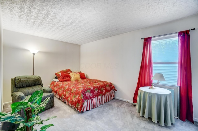 carpeted bedroom featuring a textured ceiling