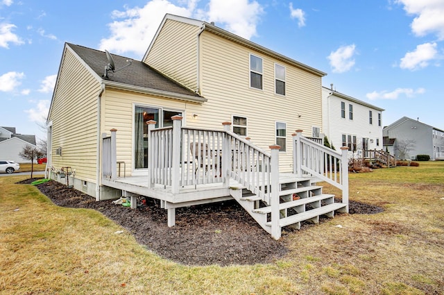 rear view of house with a yard and a deck