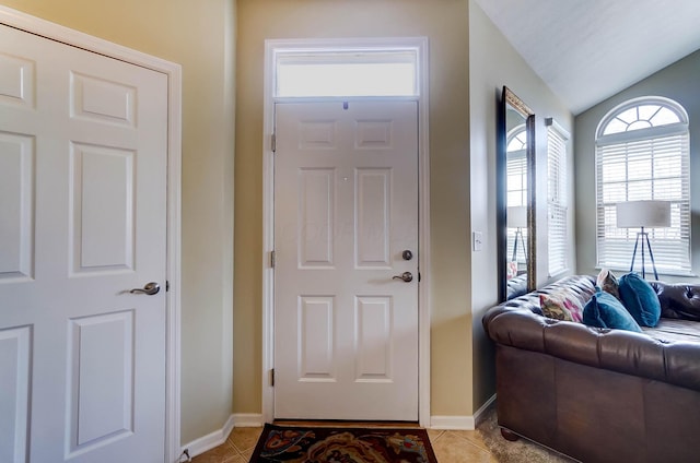 entrance foyer with vaulted ceiling and light tile patterned floors