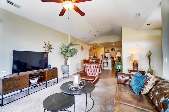 living room with hardwood / wood-style flooring, lofted ceiling, and ceiling fan