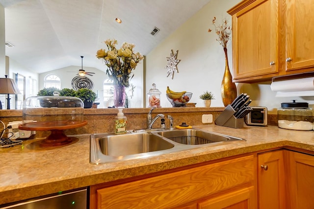 kitchen with vaulted ceiling, sink, stainless steel dishwasher, and ceiling fan