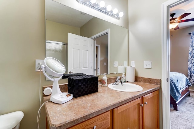 bathroom with vanity, an enclosed shower, toilet, and ceiling fan