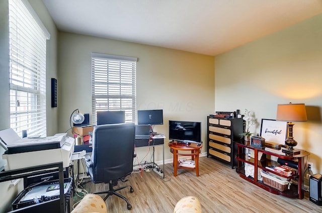 office area with light hardwood / wood-style floors