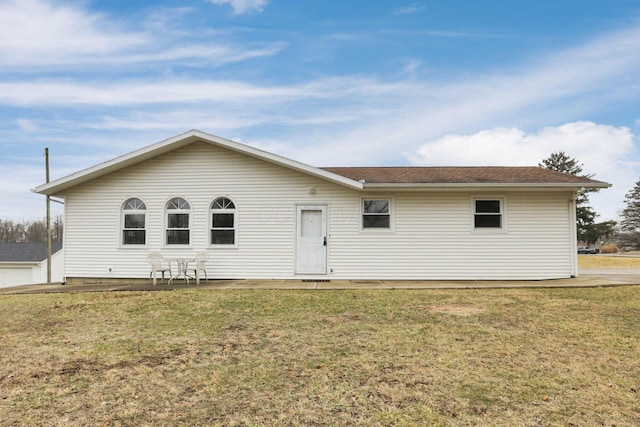 rear view of property featuring a yard