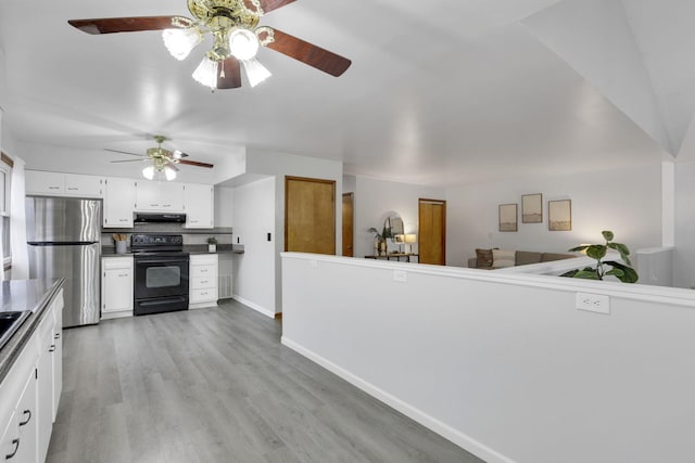 kitchen with stainless steel refrigerator, white cabinets, decorative backsplash, black range with electric cooktop, and light hardwood / wood-style flooring