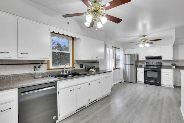 kitchen featuring sink, white cabinetry, backsplash, black appliances, and light wood-type flooring