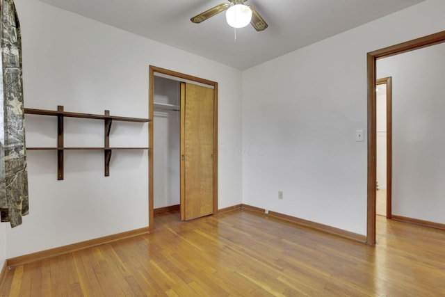 unfurnished bedroom featuring ceiling fan, a closet, and light hardwood / wood-style flooring