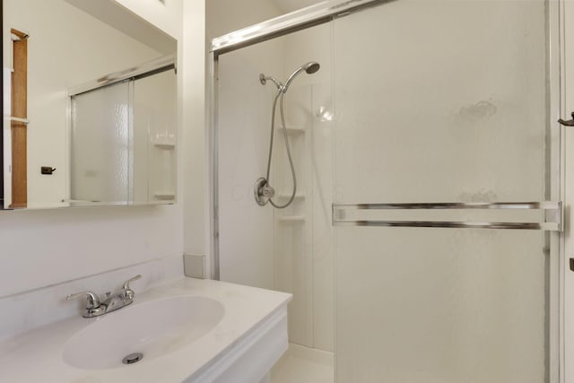 bathroom featuring an enclosed shower and sink