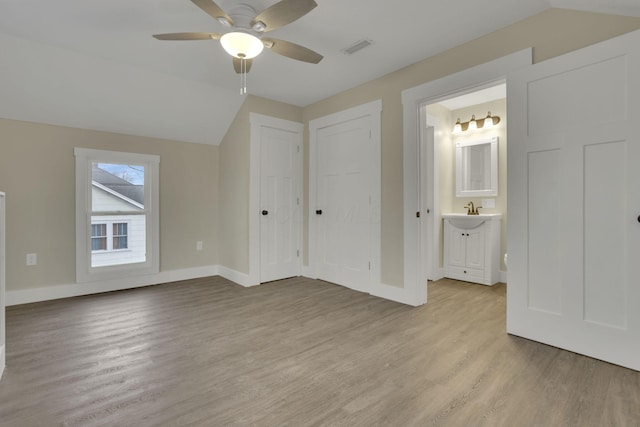 additional living space with vaulted ceiling, ceiling fan, and light wood-type flooring