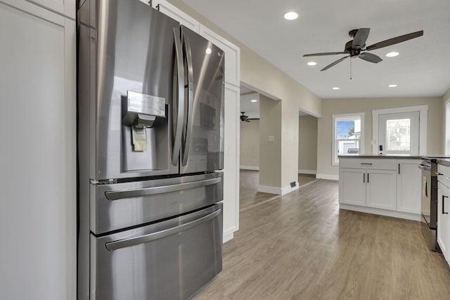 kitchen featuring appliances with stainless steel finishes, white cabinets, ceiling fan, and light hardwood / wood-style flooring