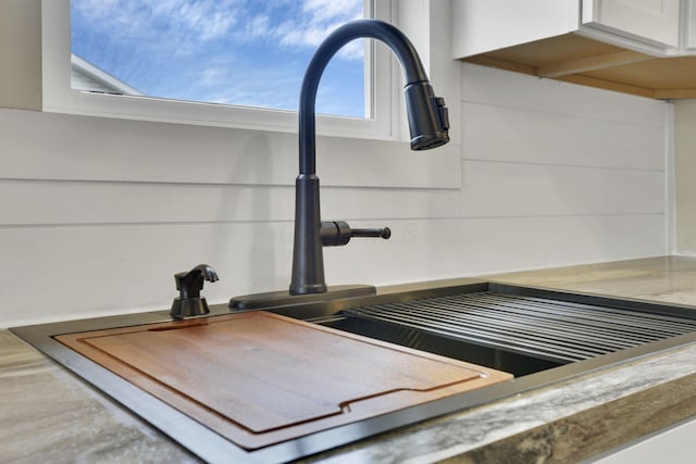 details featuring white cabinetry and sink