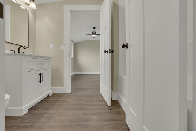 bathroom featuring vanity, hardwood / wood-style floors, and toilet