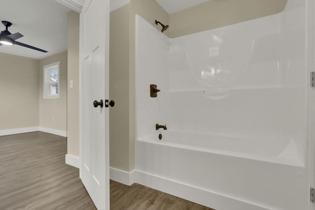 bathroom with wood-type flooring, ceiling fan, and shower / tub combination