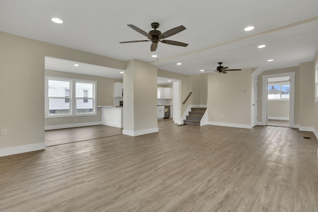 unfurnished living room with ceiling fan and light hardwood / wood-style flooring