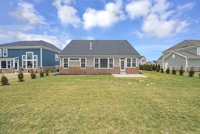 back of property with a yard and a patio