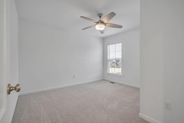 carpeted spare room with ceiling fan