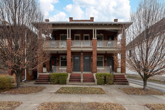 view of front of home featuring a balcony and covered porch