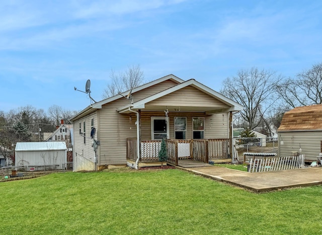 rear view of house featuring a patio and a lawn