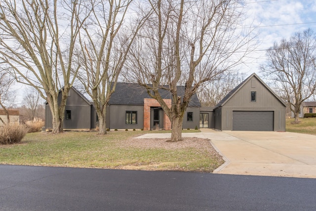 view of front of house featuring a garage and a front lawn