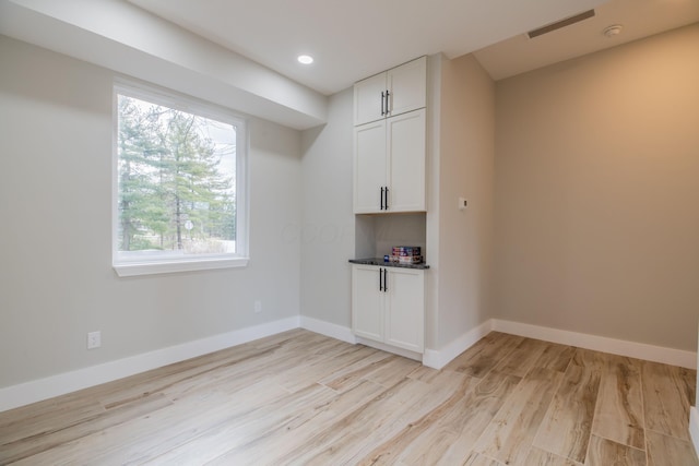 unfurnished room with light hardwood / wood-style flooring