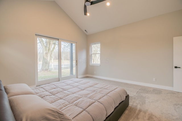 carpeted bedroom with ceiling fan and high vaulted ceiling