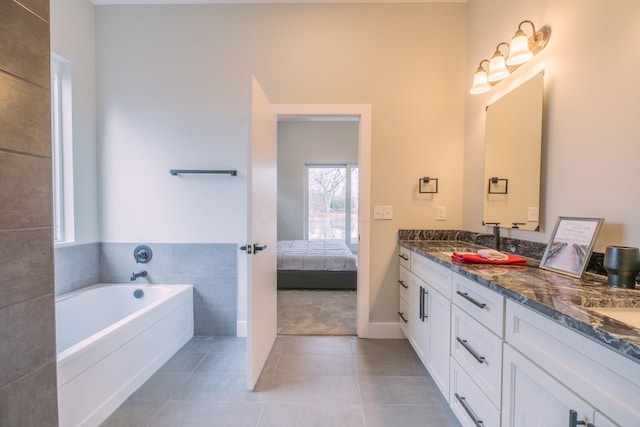 bathroom featuring vanity, tile patterned flooring, and a bathtub