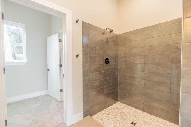 bathroom featuring a tile shower