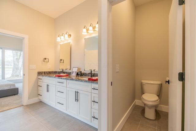 bathroom with tile patterned floors, vanity, and toilet