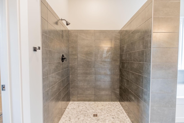 bathroom with a tile shower