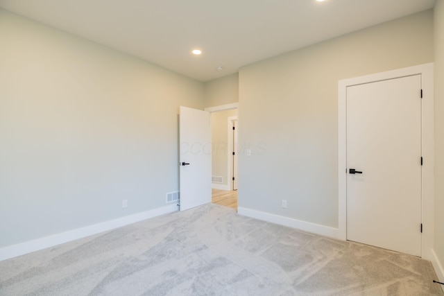 empty room with light colored carpet