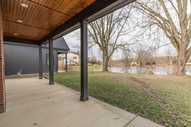 view of yard featuring a water view and a patio area