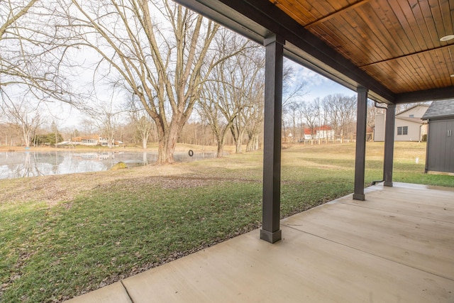 view of yard with a water view and a patio area