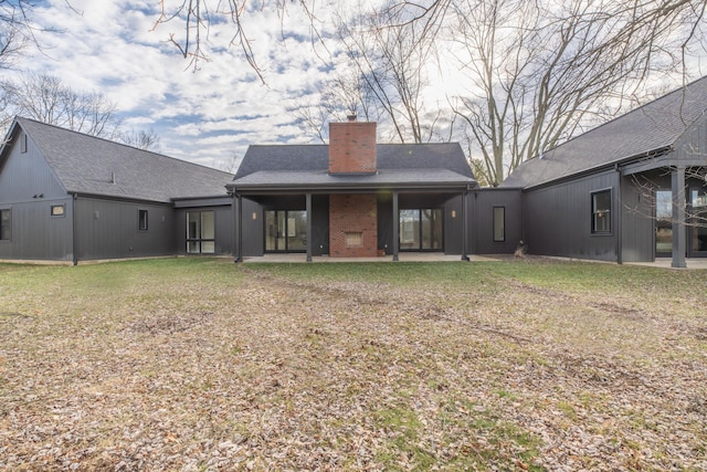 rear view of house with a lawn