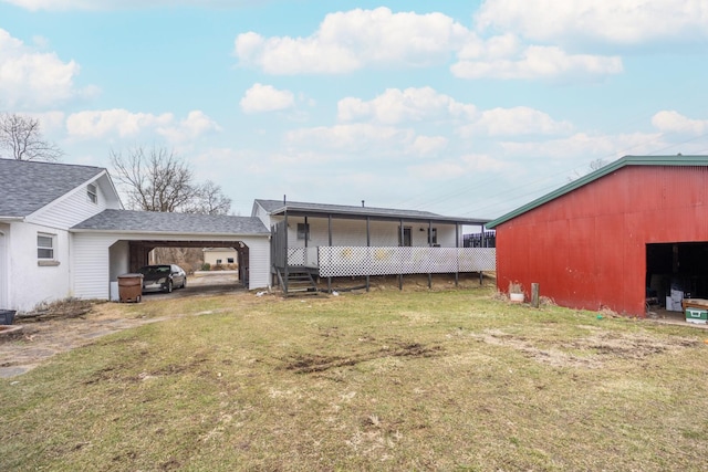 rear view of property featuring a carport and a lawn