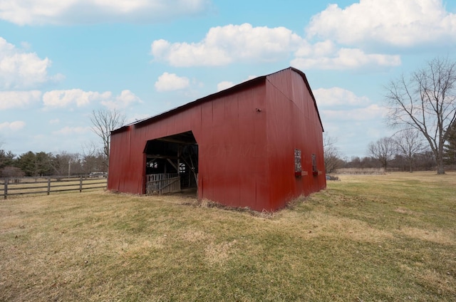 view of outdoor structure featuring a rural view and a yard