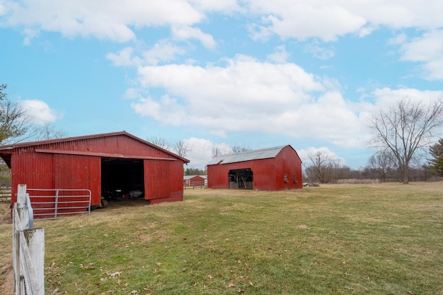 view of yard with an outdoor structure and a rural view