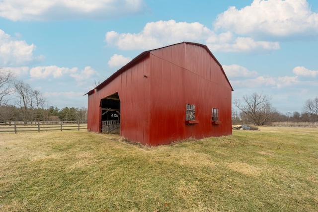 view of outdoor structure with a rural view and a lawn